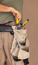 Worker uses tool belt