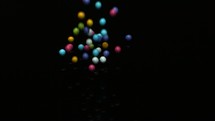 slow motion colorful candy spilling on a black background 