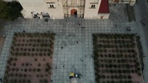 Tilt up shot Of People At The Courtyard In Front Of Santo Domingo Church In Oaxaca, Mexico.