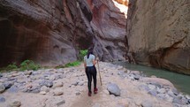 Young Woman on Hiking Adventure in the Narrows Slot Canyon in Zions, Utah