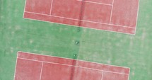 Top View Of Red Tennis Courts On Green Field. aerial drone, screwdriver shot