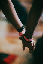 holding hands in prayer at a Christian concert 