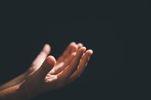 Hands open in prayer
