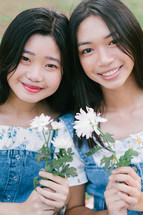 girls holding flowers 