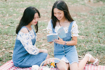 reading a book on a picnic blanket 
