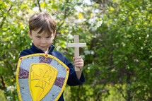 boy armed with shield and cross