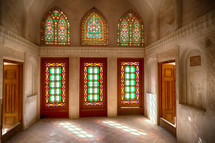 colors from stained glass windows inside on old mosque in Iran 