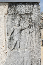 The stone engraving depicts a gladiator at the gate. This historic theater in Philippi would have been visited by the Apostle Paul, Silas, Lydia and early Christians from Acts 16. The theater would have housed dramas and gladiator fights.