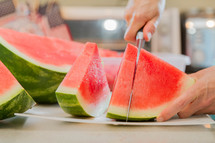 man cutting a watermelon 
