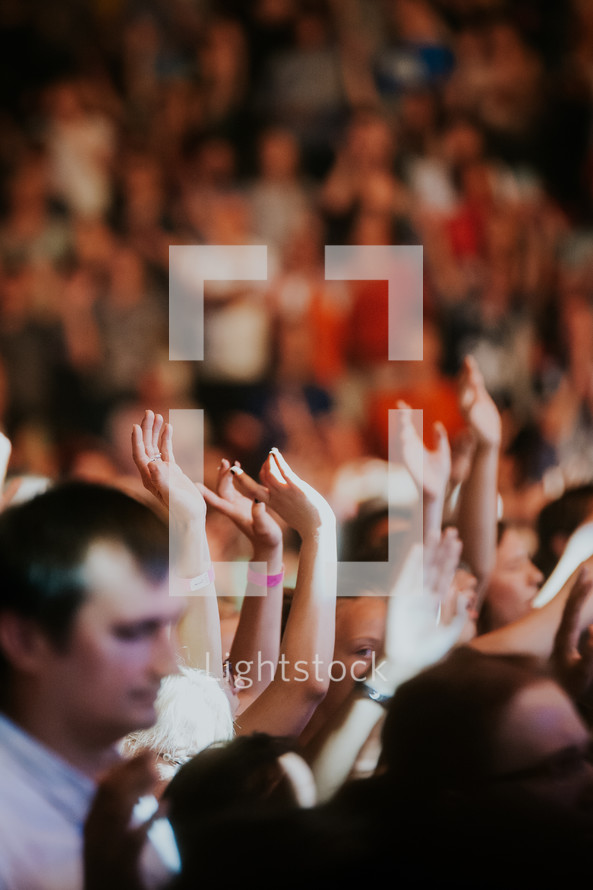 hands raised in worship at a Christian concert in Prague 