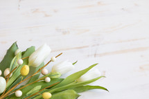white tulips and Easter eggs on branches 
