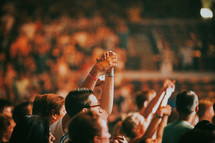 holding hands raised in worship at a concert in Prague 