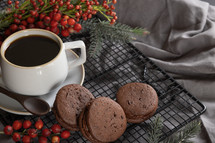 chocolate sandwich cookies and coffee, red berries 