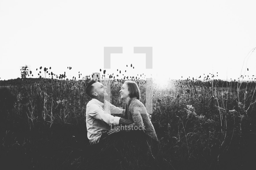 a couple sitting in a field 
