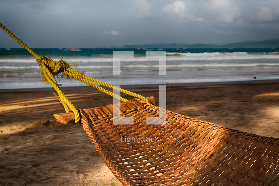 A hammock near an ocean beach.