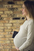 an pregnant woman holding her belly 