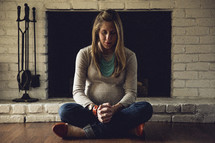 a pregnant woman praying on the floor 