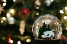 Christmas snow globe with house and tree