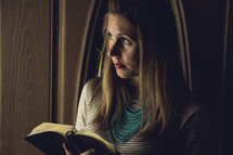 a woman holding a bible 