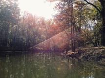 sunbeams on a lake in fall 
