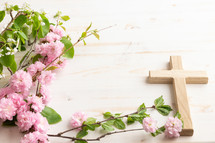 Cross with branch with pink flower blossoms