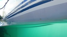 50/50 Over/Underwater of White Yacht Hull with Blue Stripes, Dublin, Ireland
