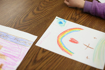 a child coloring religious artwork 
