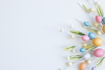 Decorative sprigs with easter eggs on white
