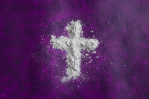 ashes in the shape of a cross on purple 