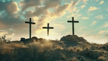 Three wooden crosses on hill top with sun beams and clouds in sky