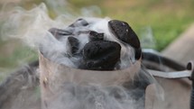 smoke from coals on a grill 