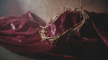 purple fabric and crown of thorns 