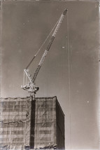 construction crane on a roof top 