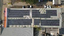 Aerial top down view moving up above solar panels
