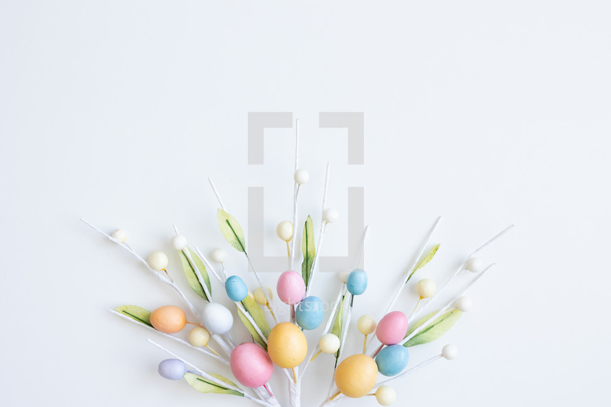 Decorative sprigs with easter eggs on white