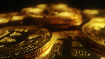 Many bitcoin coins placed on black background
