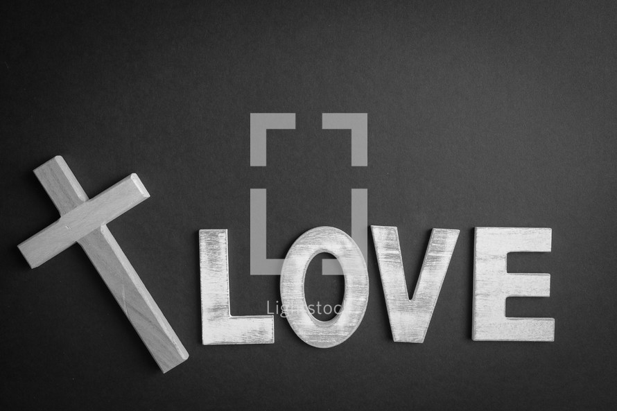 Black background with the word "love" and a cross