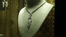 Expensive silver and diamond necklace in store shop. window in Dubai mall.