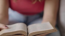Hand Turning Pages of a bible, close up and slowmotion. 
