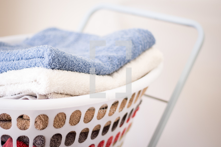 Stack of Towels in Washing Basket