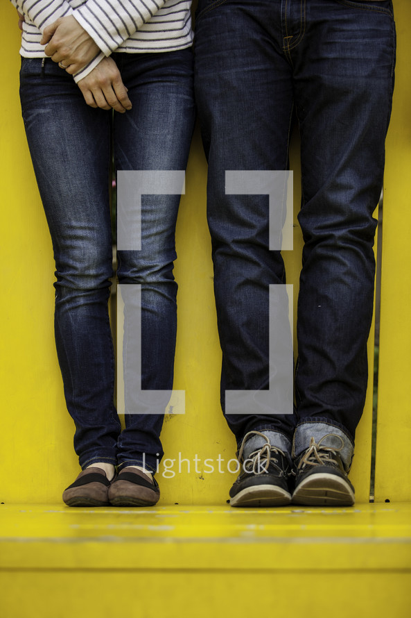 legs of a couple in jeans 