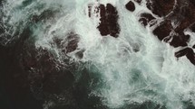 waves crashing into rocks (rotating shot)