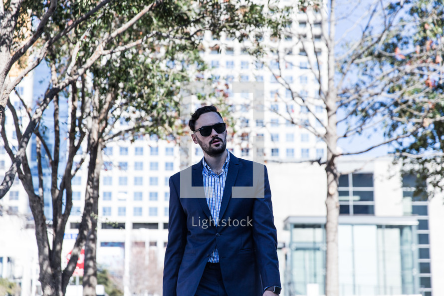 man in a sports coat walking in a city