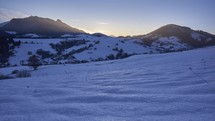 Winter mountain hilly landscape at dusk, blue sky, end of day, sunset, timelapse
