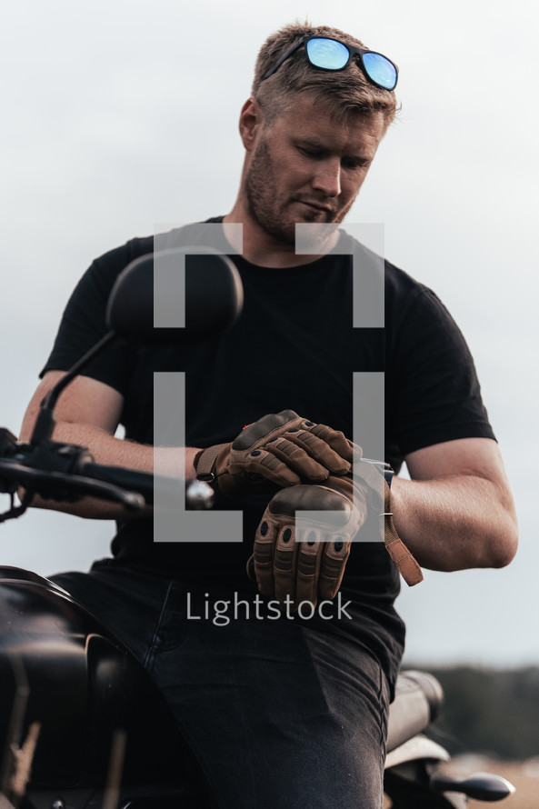 Man in black t-shirt riding a motorcycle, motorbike rider