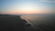 Aerial drone shot of waves of Langeoog Island, Germany at the sunset.