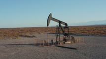 Working pumpjack extracting oil to the surface in Mendoza Province, Argentina. Aerial made from flying drone
