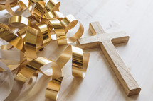 gold streamers and cross on a white background