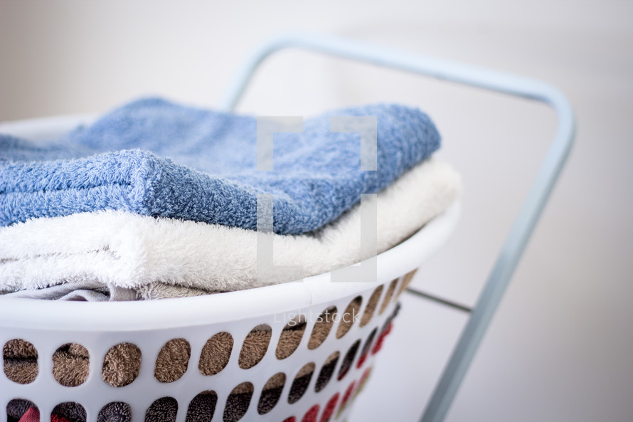 Stack of Towels in Washing Basket 