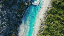 aerial view over a turquoise river 